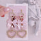 <09006>Ribbon and two heart Earrings